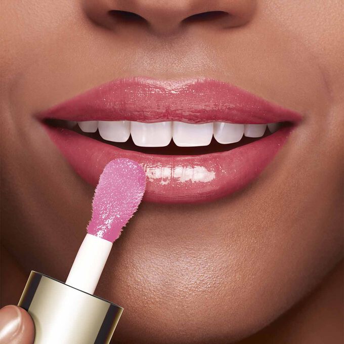 Close-up of a woman's lips showing the effect of Clarins Lip Comfort Oil.