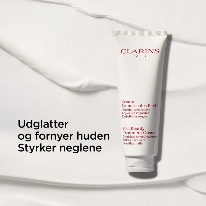 Packshot of Clarins Foot Beauty Treatment Cream on a creamy-textured background with text emphasising its nourishing benits