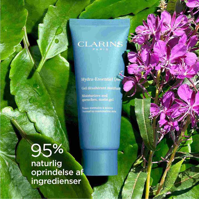 Packshot of Clarins Hydra-Essentiel Matte Gel among Alpine willowherb, highlighting its 92% natural origin ingredients.