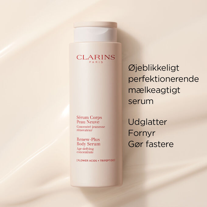 Clarins Instant Perfecting Milky Serum for the body on a textured creamy background to emphasize its smoothing and firming action