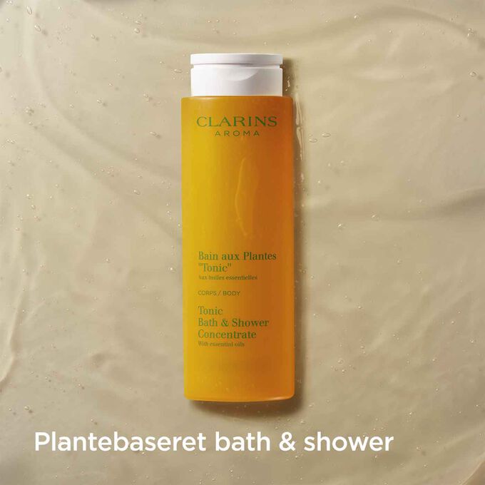 Packshot of Clarins Tonic Bath and Shower Concentrate with text emphasising it is a fragrant plant-based shower gel.