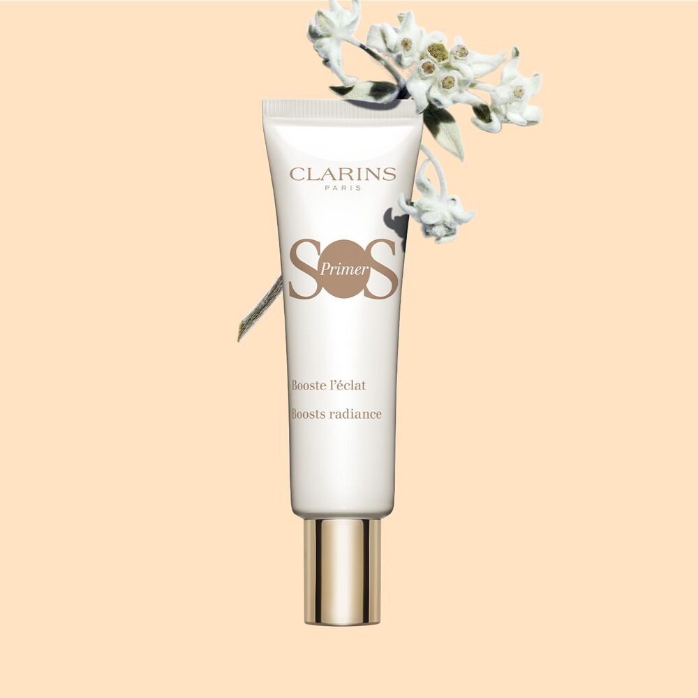 Packshot of a tube of SOS Primer White by Clarins, feauturing edelweiss flowers, to boost glow and increase skin luminosity.