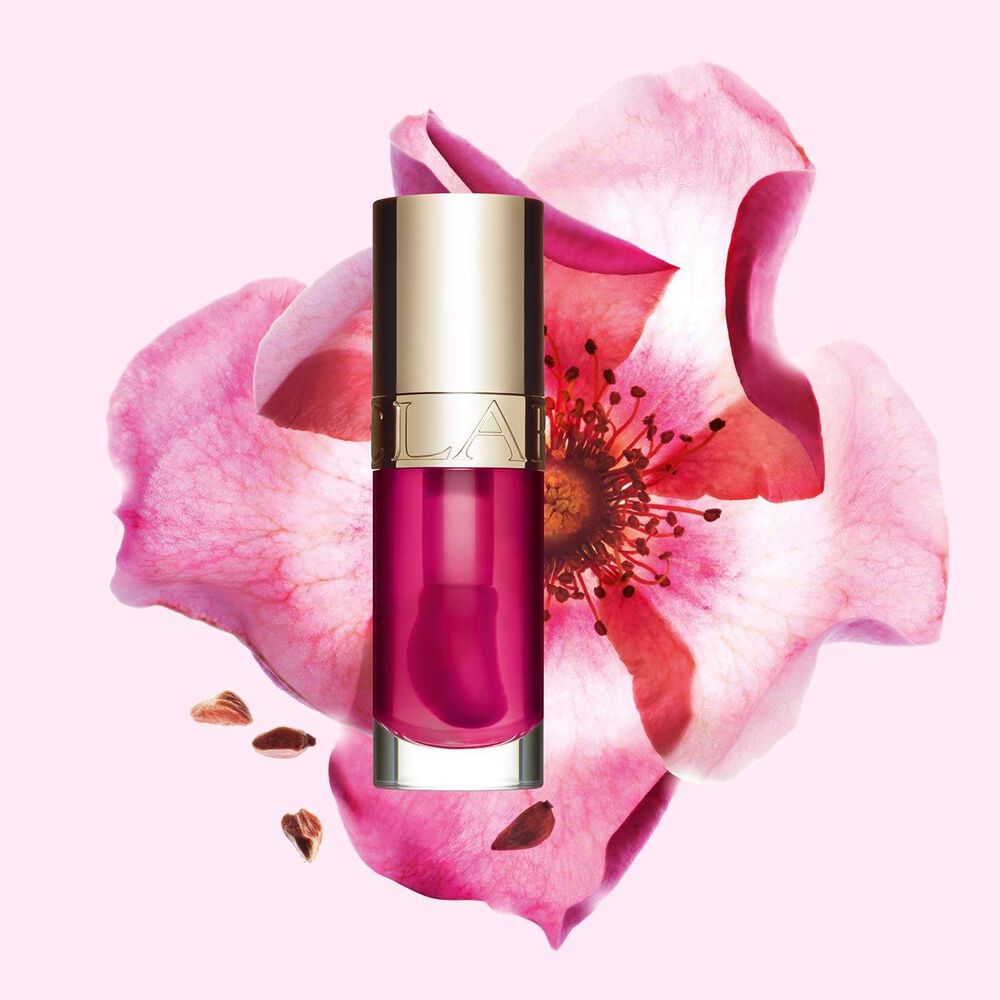 Packshot of Clarins Lip Comfort Oil 02 Rasberry with a Sweetbriar rose, showcasing its natural ingredient skincare formula.